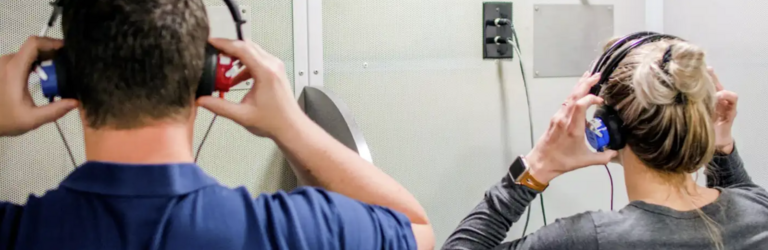 two people putting on headphones