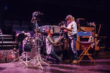 two men on stage setting up a lighting rig